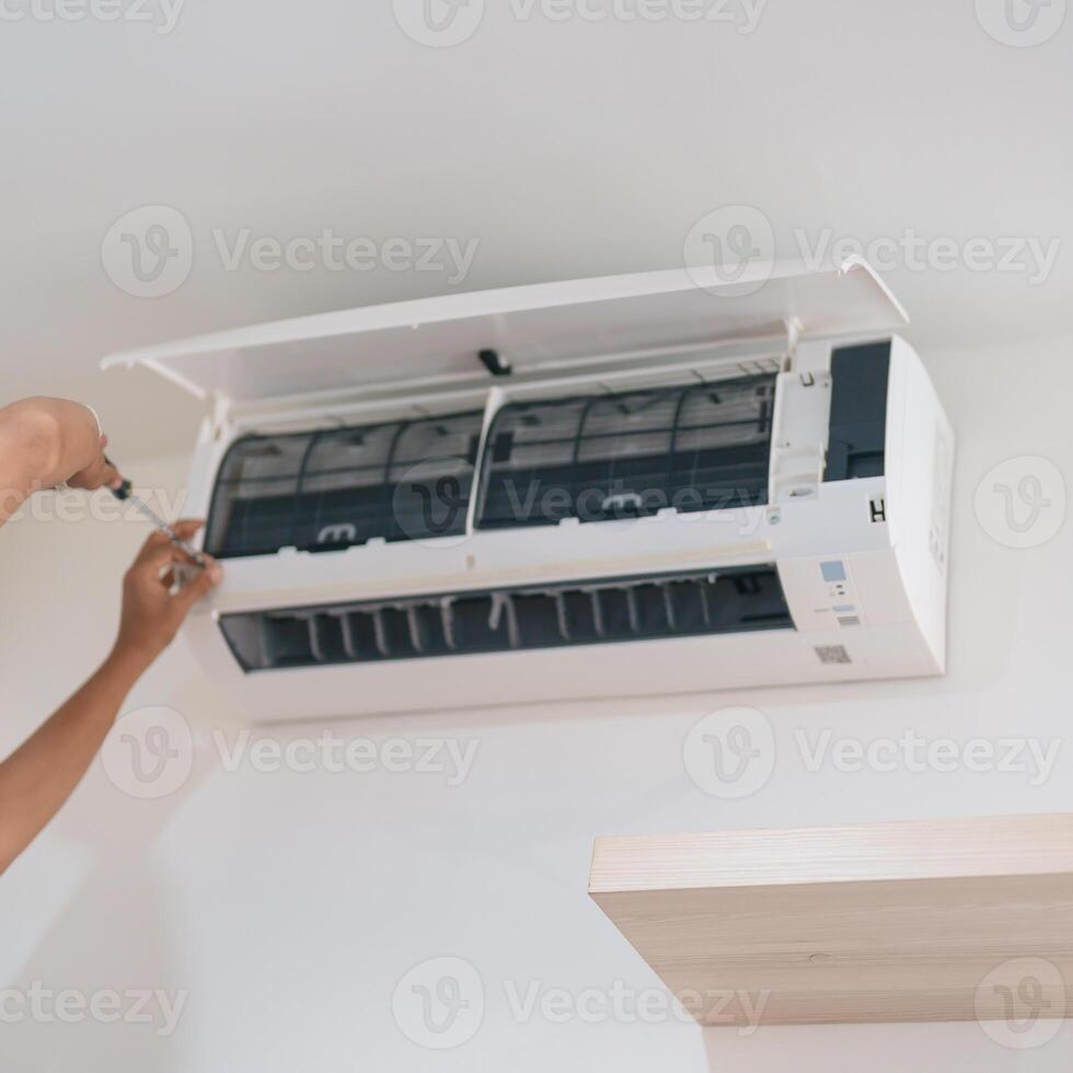 Man technician maintenance air conditioner. Purification system for cleaning dust PM2.5 and virus in home. Repair, Washing, Conditioning Service, Allergy, Pure air, health, Wellness and Air Pollution photo