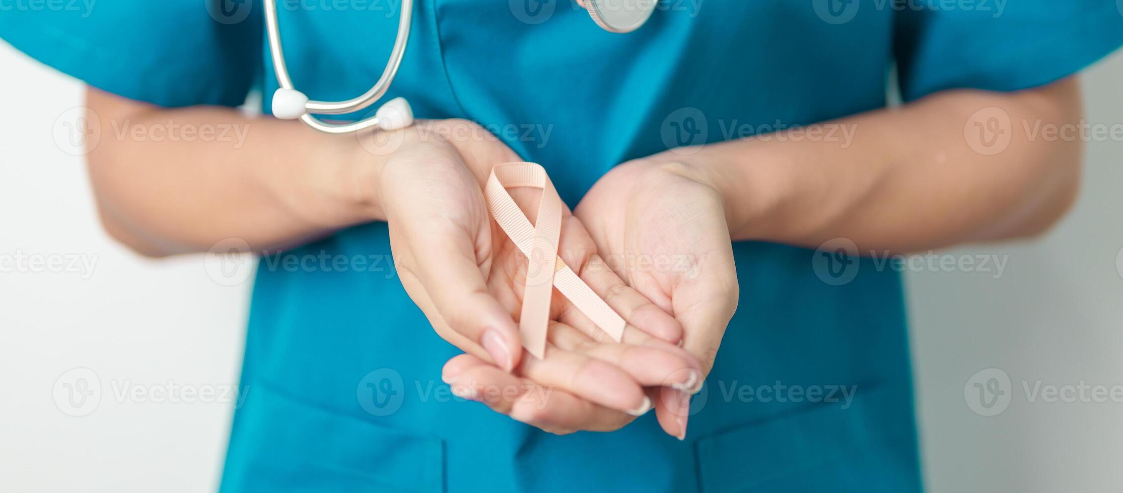 Doctor holding Peach Ribbon for September Uterine Cancer Awareness month. Uterus and Ovaries, Endometriosis, Hysterectomy, Uterine fibroids, Reproductive, Healthcare and World cancer day concept photo