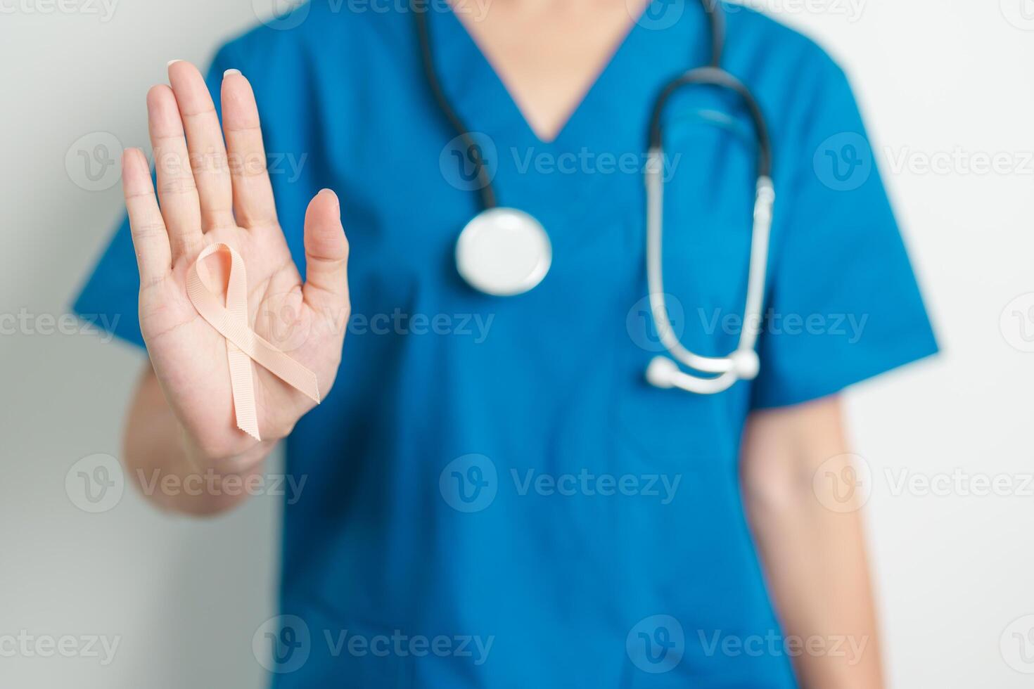Doctor holding Peach Ribbon for September Uterine Cancer Awareness month. Uterus and Ovaries, Endometriosis, Hysterectomy, Uterine fibroids, Reproductive, Healthcare and World cancer day concept photo