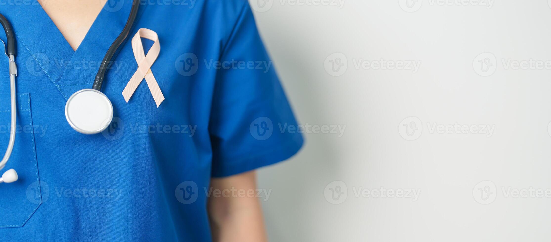 Doctor holding Peach Ribbon for September Uterine Cancer Awareness month. Uterus and Ovaries, Endometriosis, Hysterectomy, Uterine fibroids, Reproductive, Healthcare and World cancer day concept photo