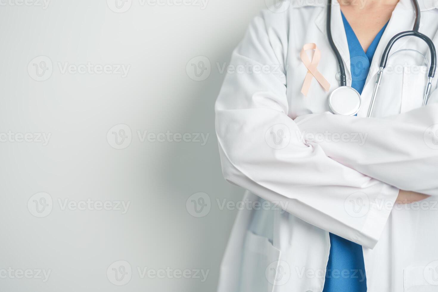 Doctor holding Peach Ribbon for September Uterine Cancer Awareness month. Uterus and Ovaries, Endometriosis, Hysterectomy, Uterine fibroids, Reproductive, Healthcare and World cancer day concept photo
