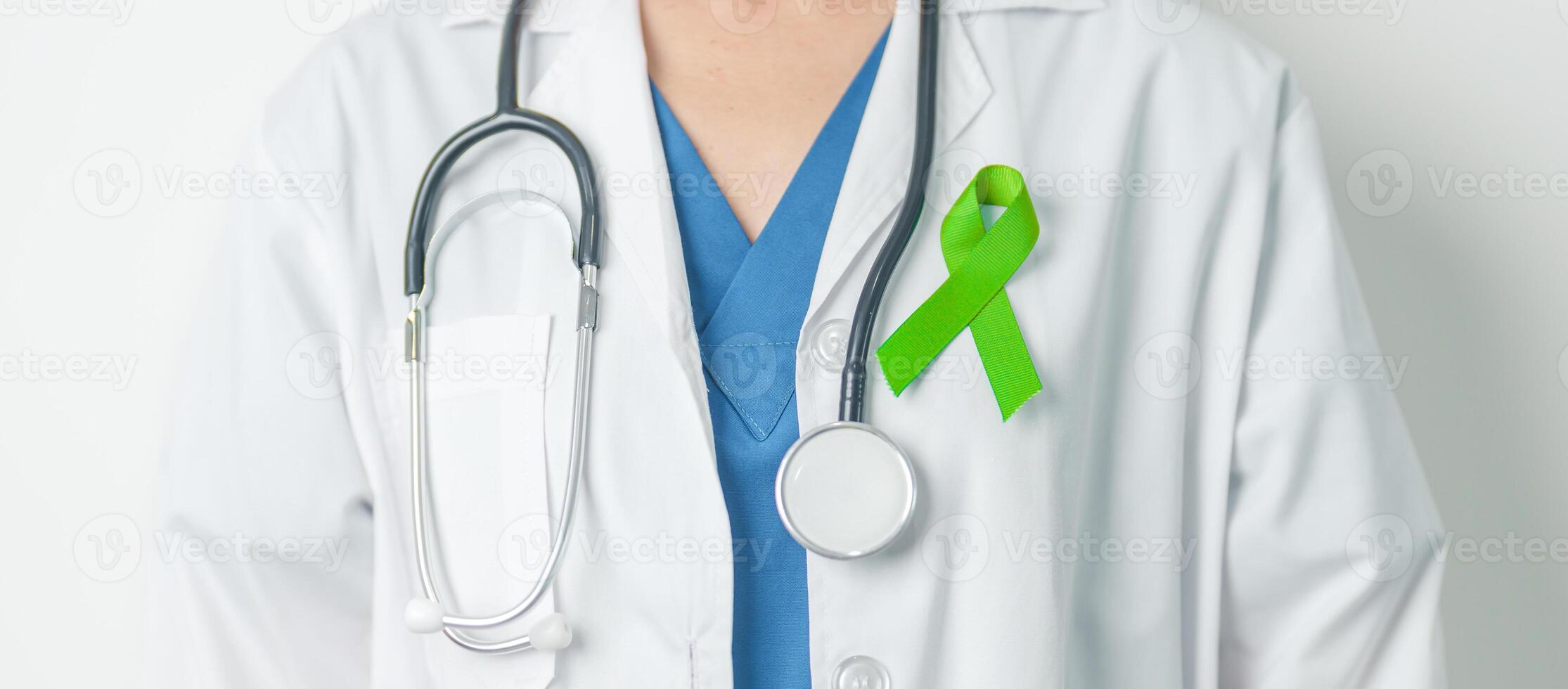 Doctor with green Ribbon for world Lymphoma Awareness September month, world Mental Health Day, Liver, Gallbladders, bile duct, cervical, kidney Cancer. Healthcare and world cancer day concept photo