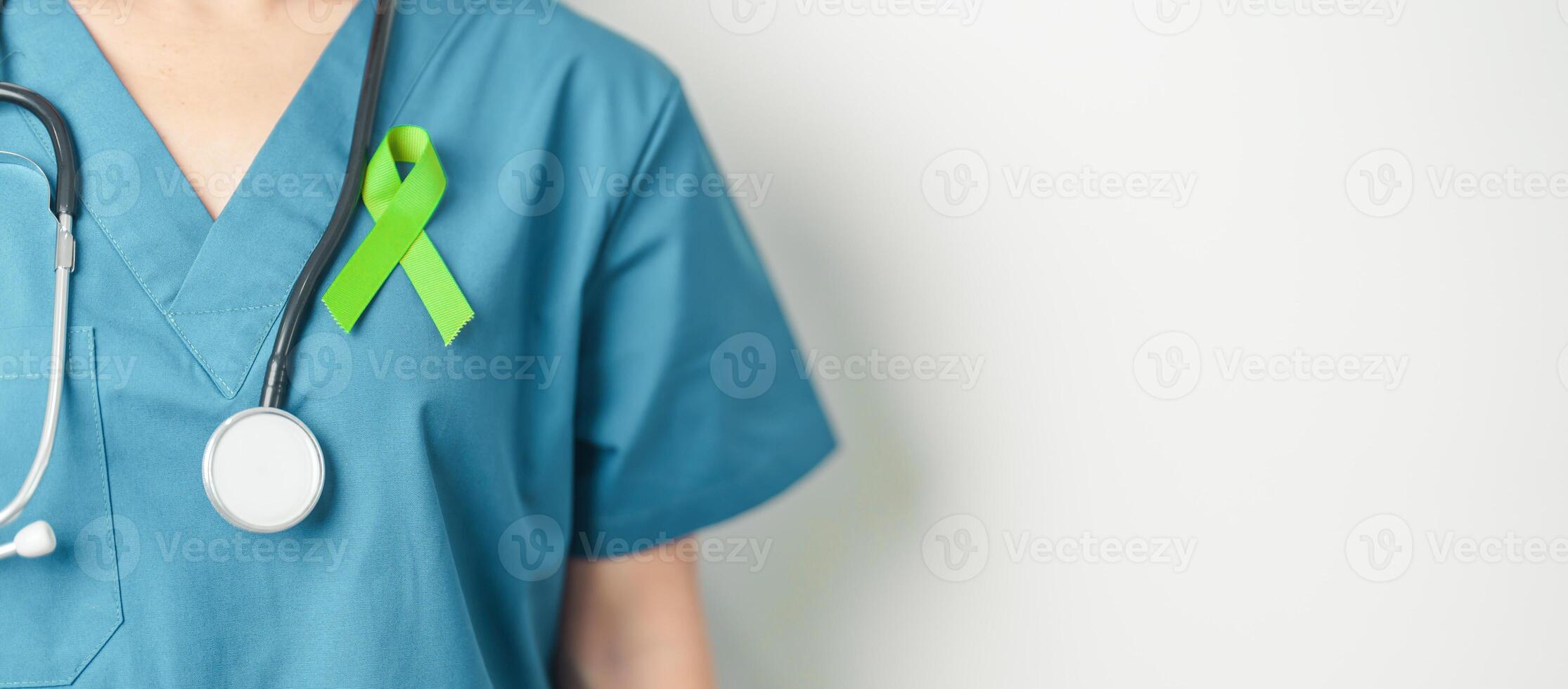 Doctor with green Ribbon for world Lymphoma Awareness September month, world Mental Health Day, Liver, Gallbladders, bile duct, cervical, kidney Cancer. Healthcare and world cancer day concept photo