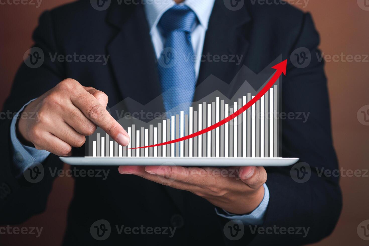 Businessman hand holding of tablet and showing a graph of statistics with arrow up. Stock market investments funds and digital assets. Business finance technology and investment concept photo