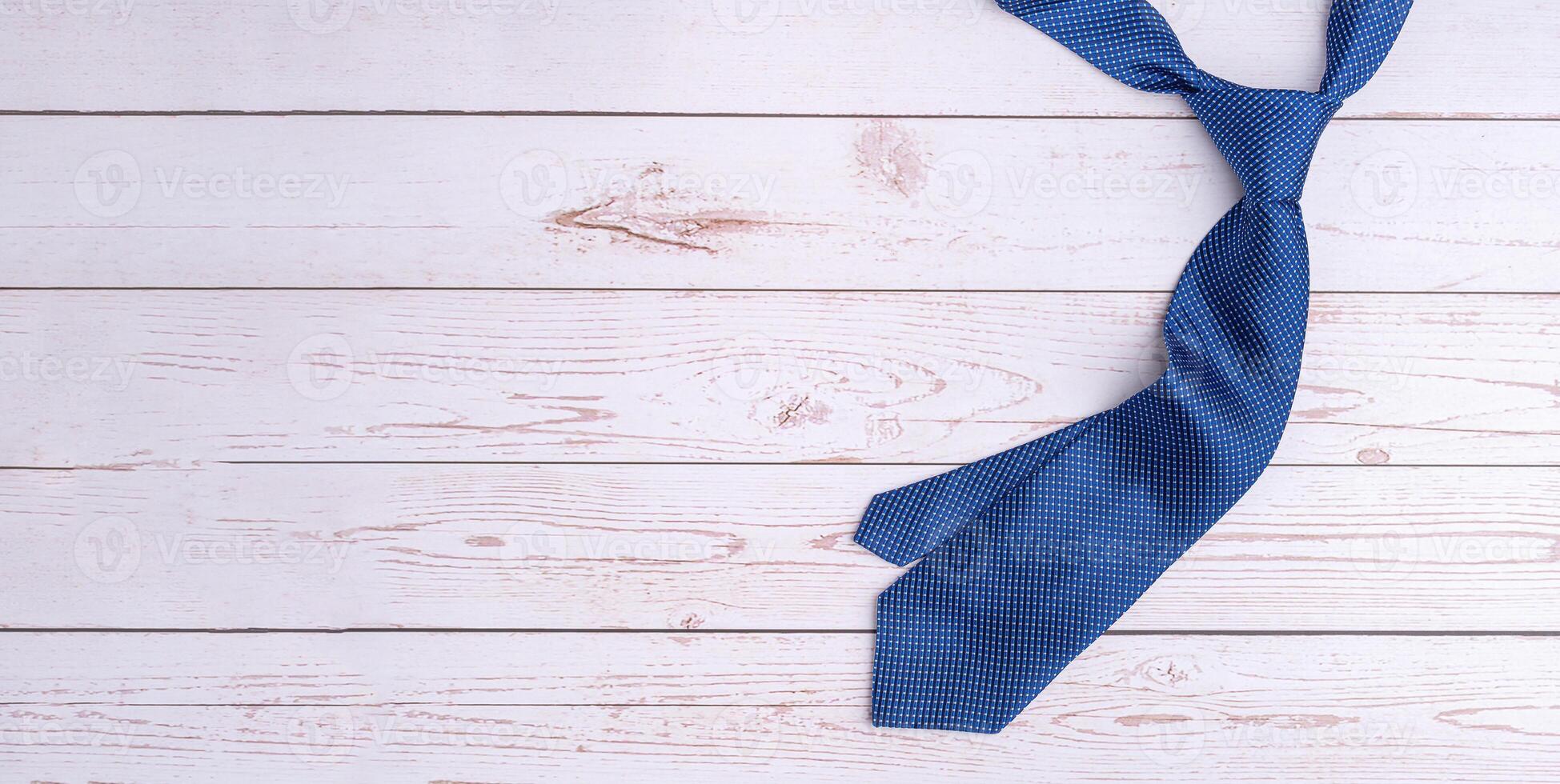 Happy Father's Day with a blue tie on wooden background with space for text. Top view. Flat lay photo