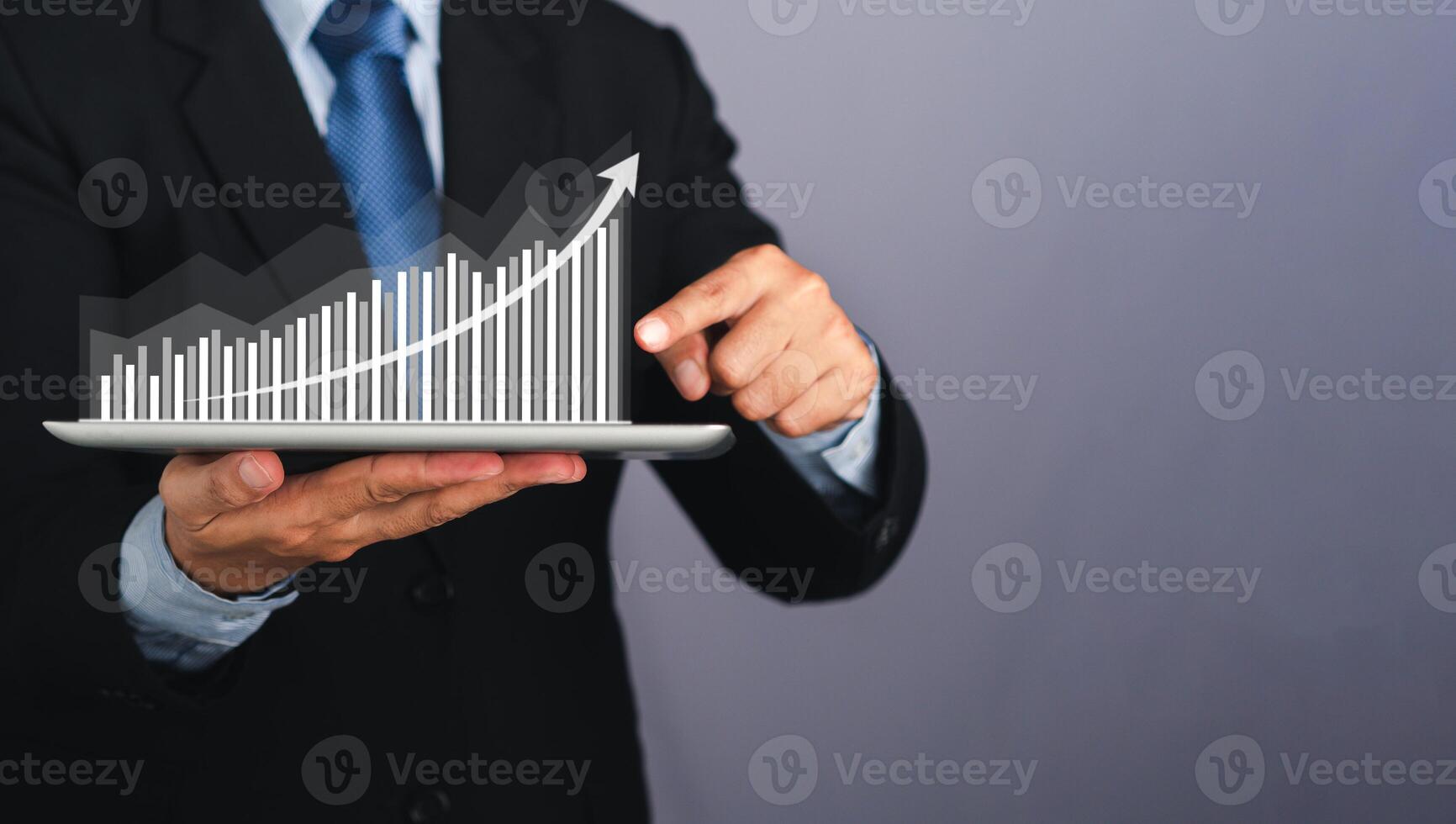 Businessman hand holding of tablet and showing a graph of statistics with arrow up. Stock market investments funds and digital assets. Business finance technology and investment concept photo