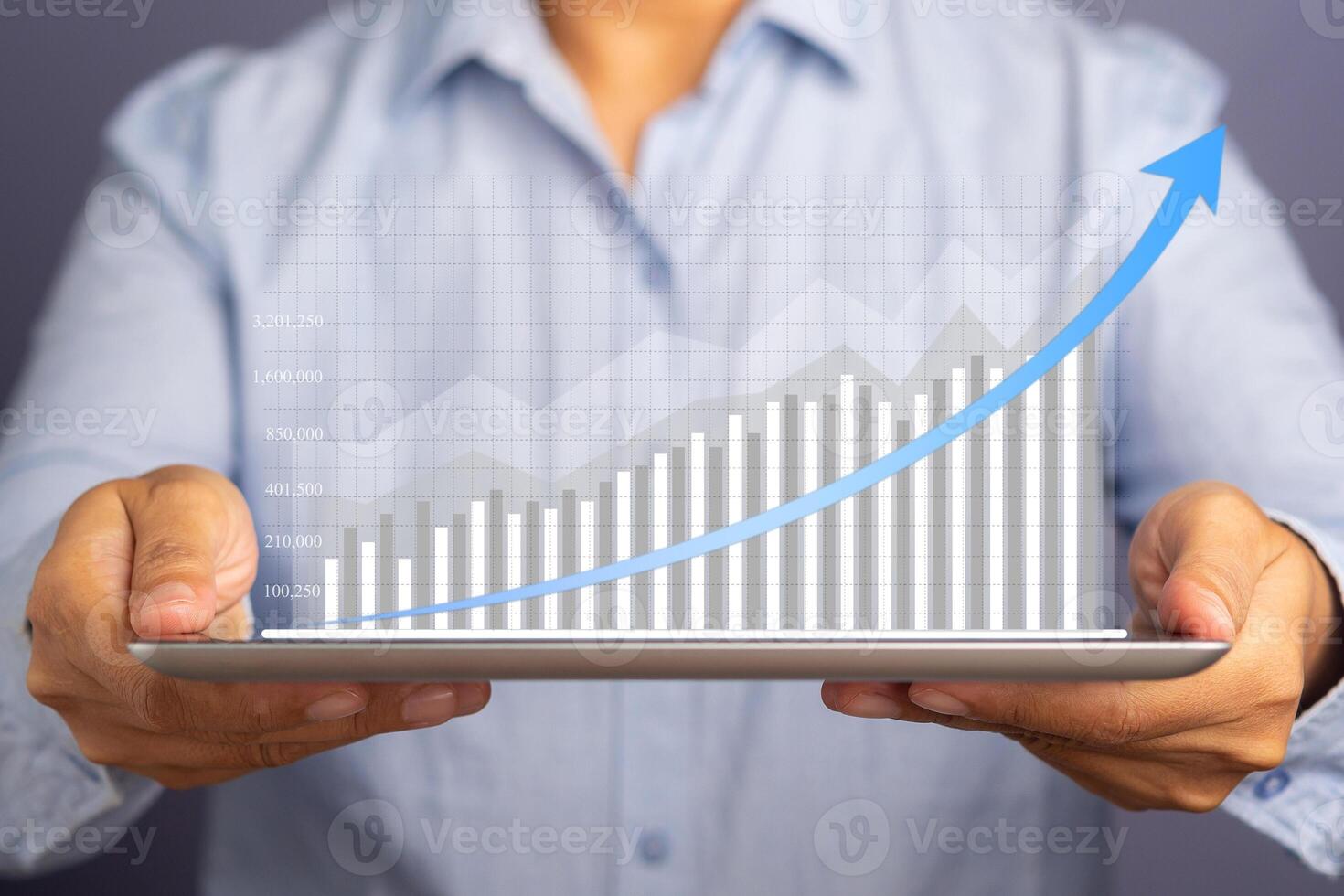 Businessman hand holding of tablet and showing a graph of statistics with arrow up. Stock market investments funds and digital assets. Business finance technology and investment concept photo