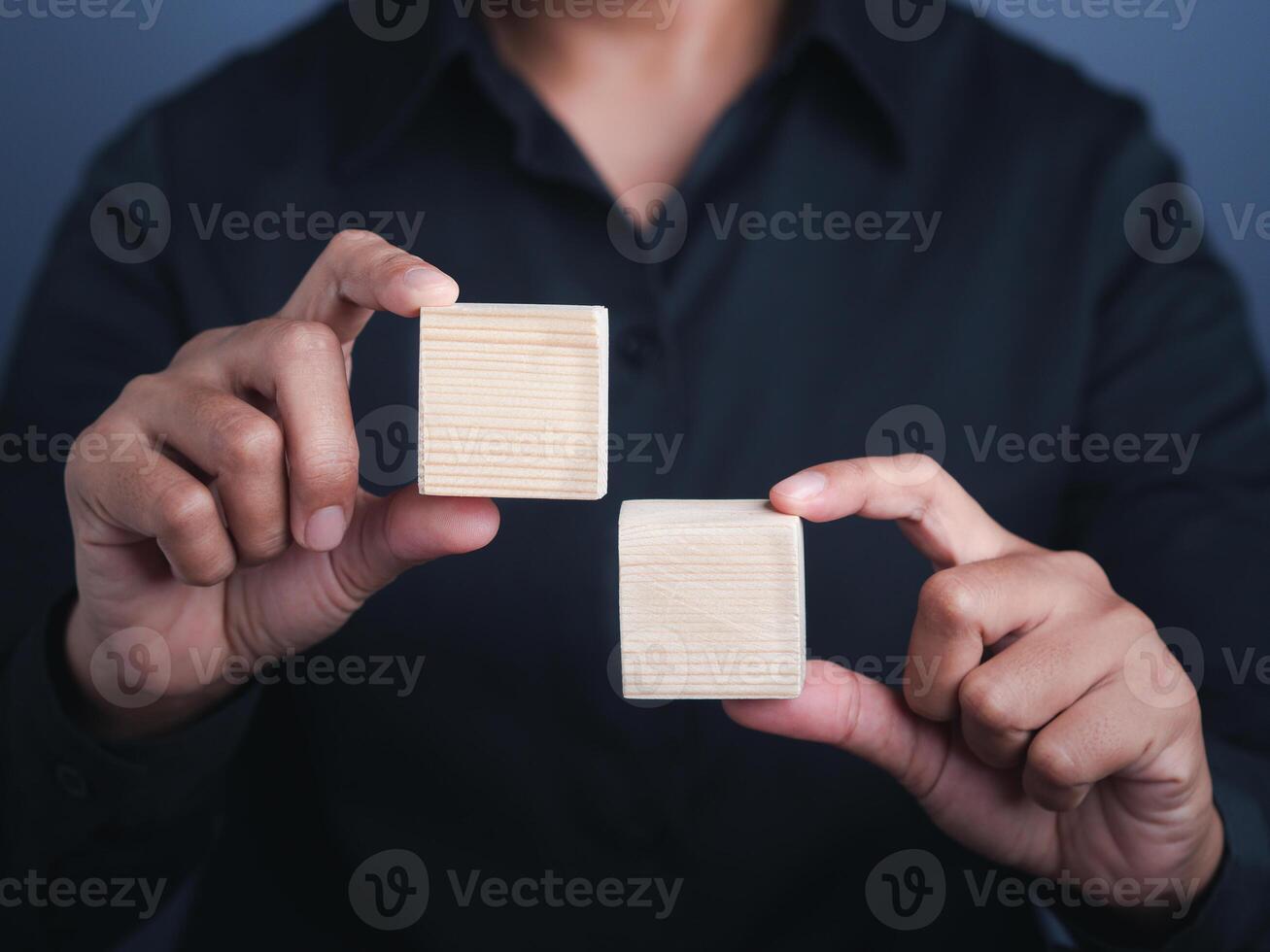 Close-up of hand holding empty wood small square pieces. Space for text photo