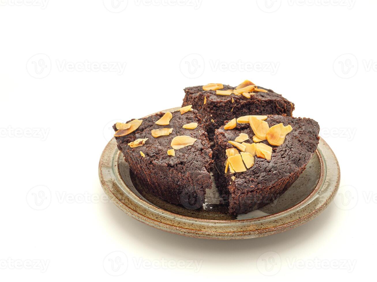 Pieces of fresh brownie on a plate with isolated white background. Side view. Delicious chocolate pie. Dessert and relaxation concept photo