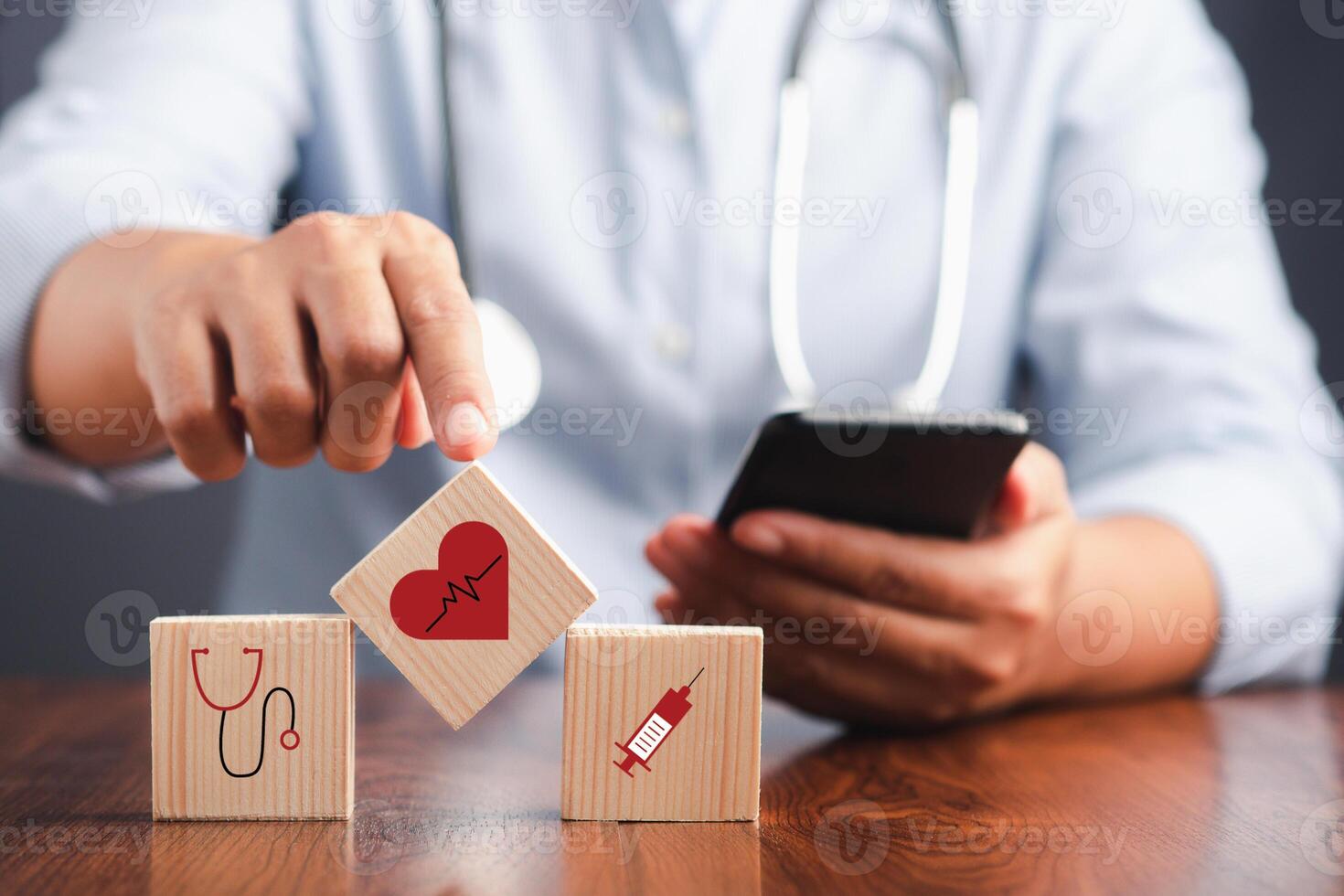 A doctor touching a wooden dice with icons of health. Close-up photo. Space for text. Concept of doctor work in maintaining human health photo