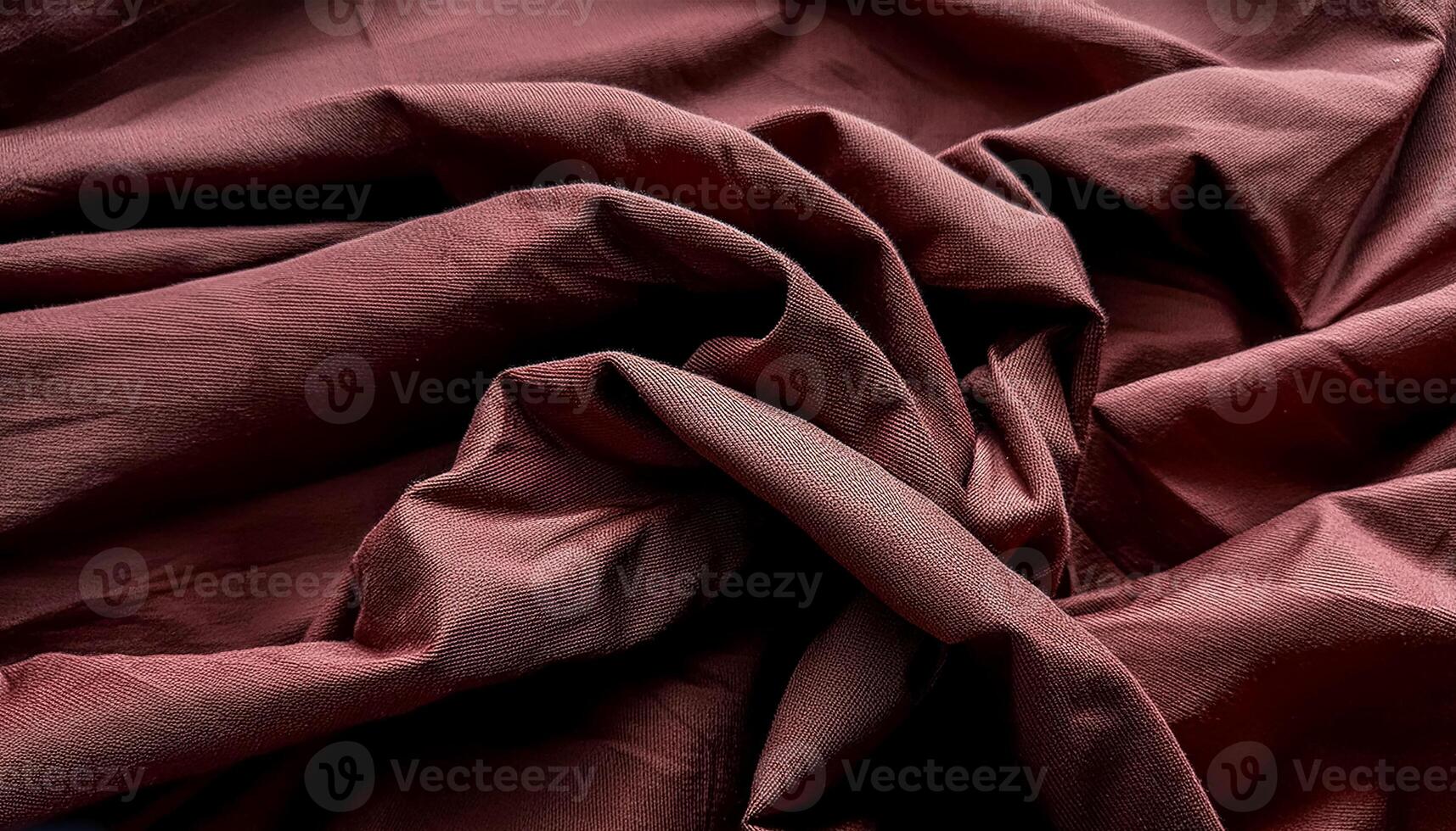 Texture of crumpled fine red cotton fabric as background. Shabby bed sheets. top view. photo