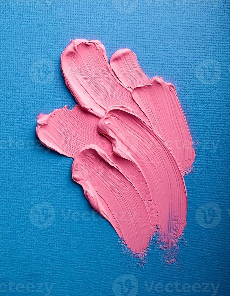 Abstract pink oil paint texture on blue canvas or wall. Minimalistic background with copy space. photo