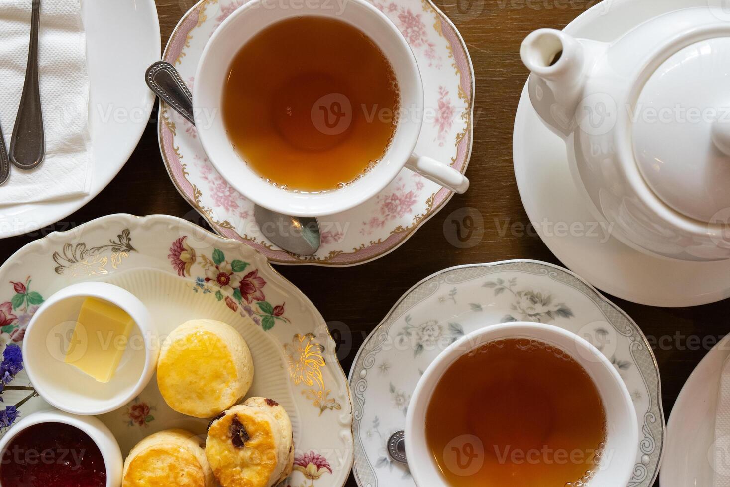 Close up of Scones Strawberry Jam and Butter Served with Hot Tea in Afterernoon photo