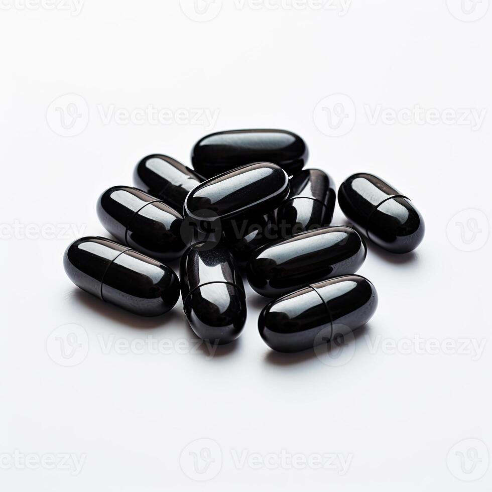 Stack of Black Pills on White Table photo