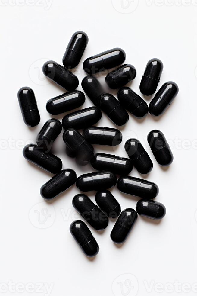 Pile of Black Pills on White Table photo
