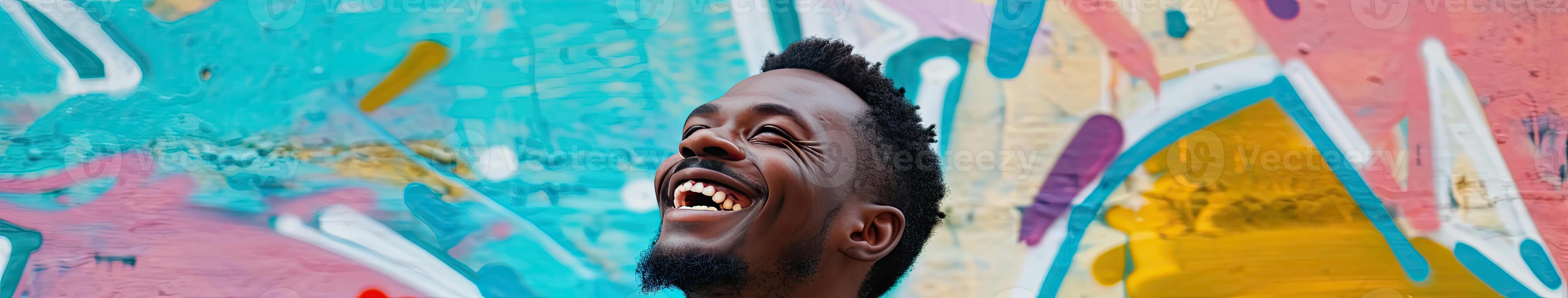 Man Laughing in Front of Colorful Wall photo