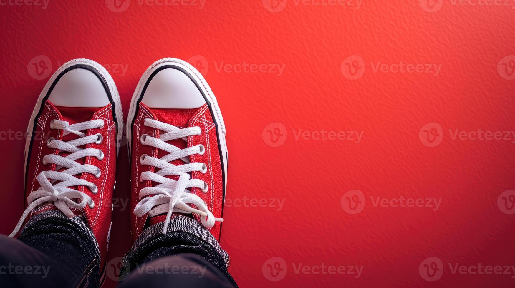 Feet With Red Sneakers on Red Background photo