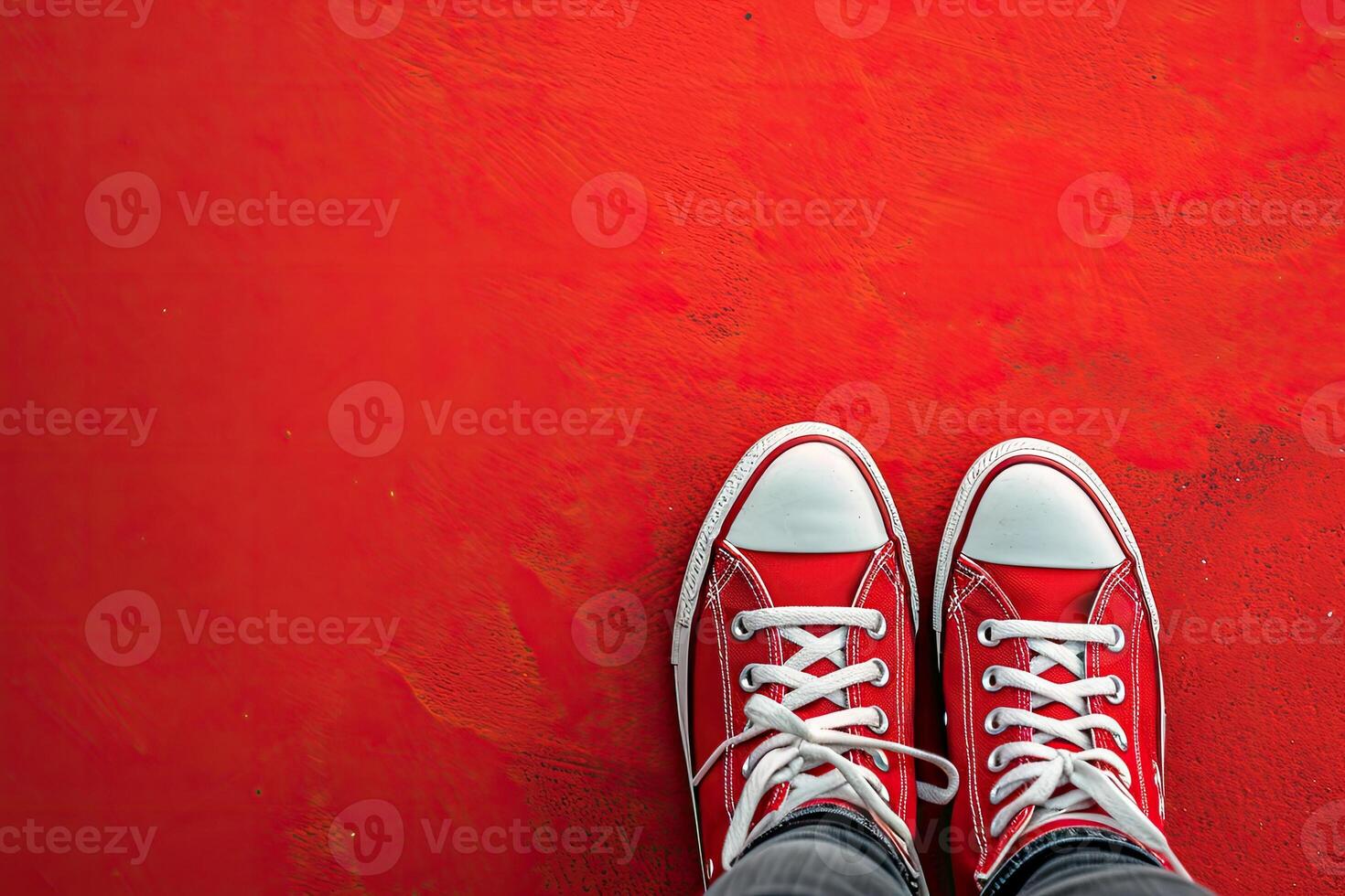 Person Wearing Red Sneakers Standing on Red Wall photo