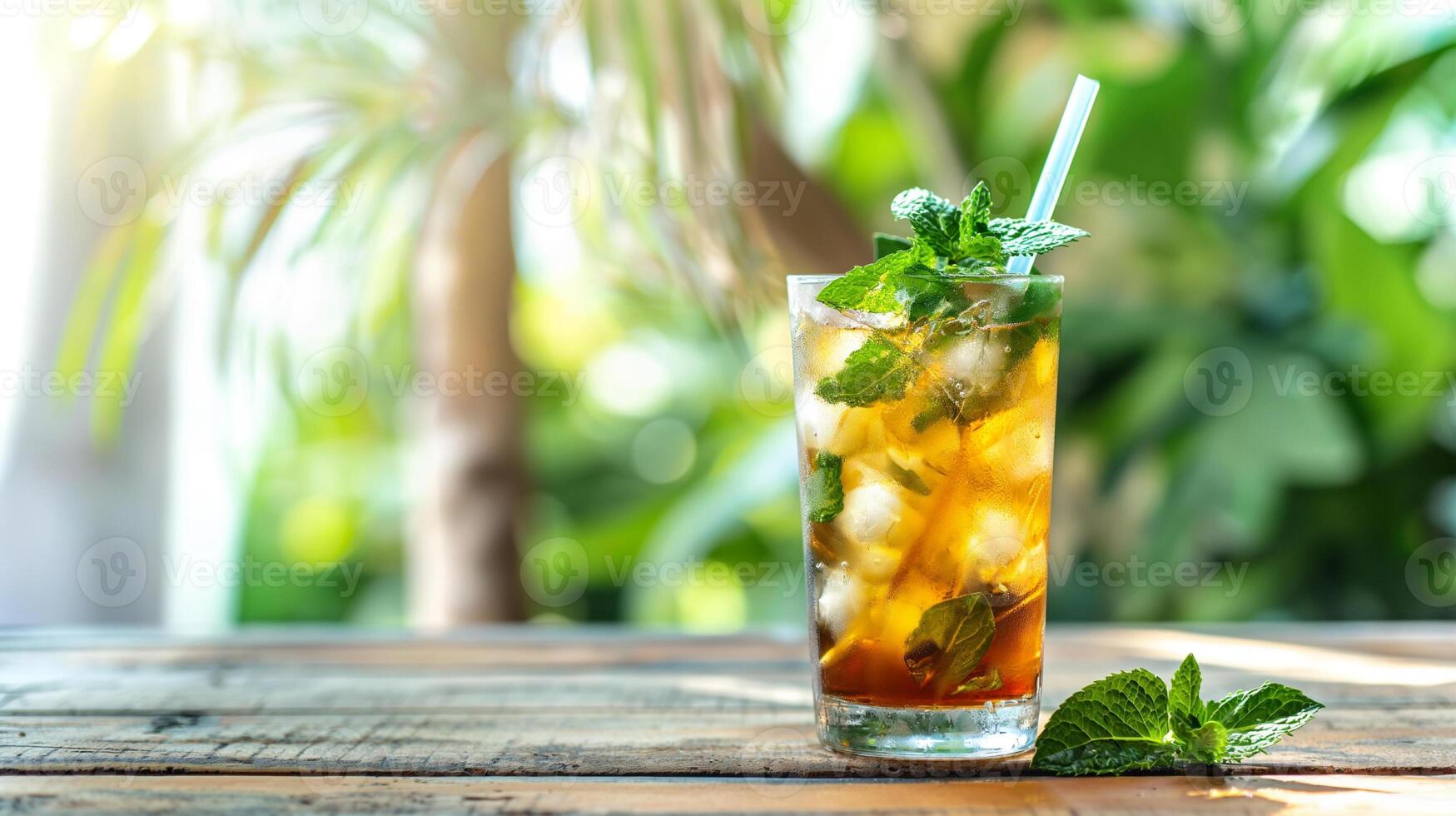 Multicolored bright cocktail with straw in a glass close up with ice cube and mint photo