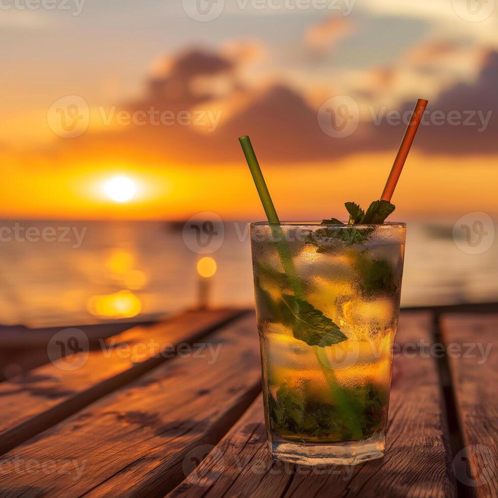Multicolored bright cocktail with straw in a glass close up with ice cube and mint photo