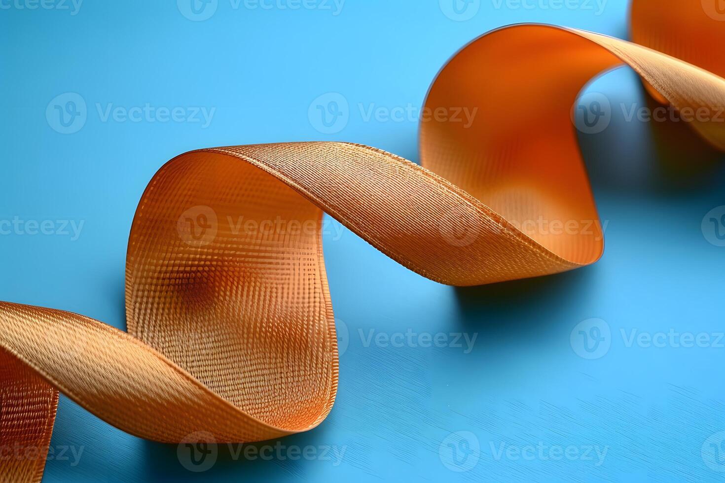 Golden Ribbon on Blue Background - Ideal for Gift Wrapping, Decorations, and Crafts photo