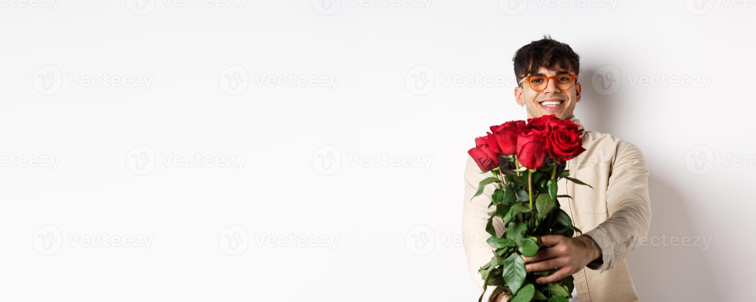 Handsome boyfriend giving you bouquet of roses, make surprise gift on romantic date at valentines day, standing with lover over white background photo
