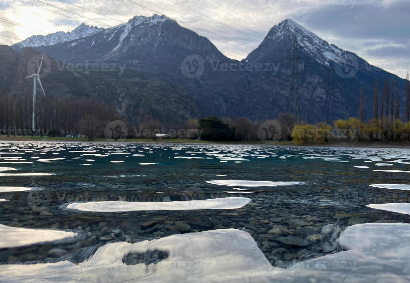 Mirror reflection of a snow-covered mountain in a lake with mountain water in Martigny, Switzerland photo