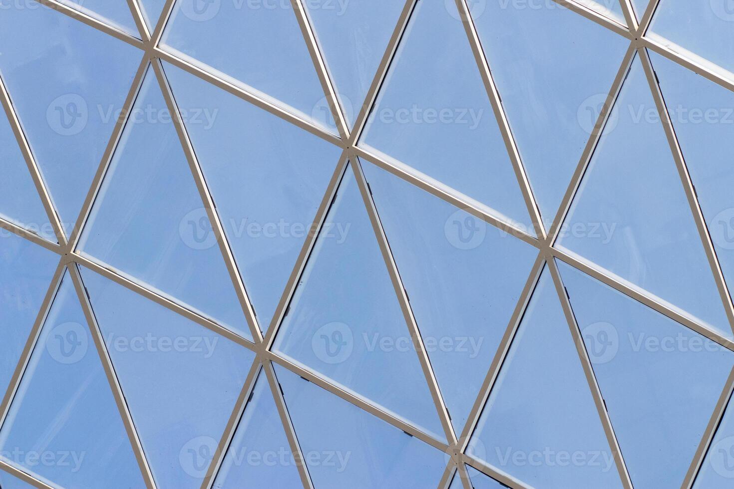 A fragment of a glass dome on the roof of the building. Geometric glass dome. Modern ceiling architecture photo