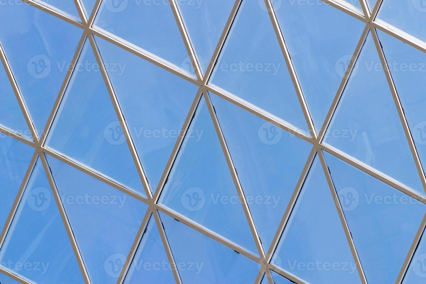 A fragment of a glass dome on the roof of the building. Geometric glass dome. Modern ceiling architecture photo