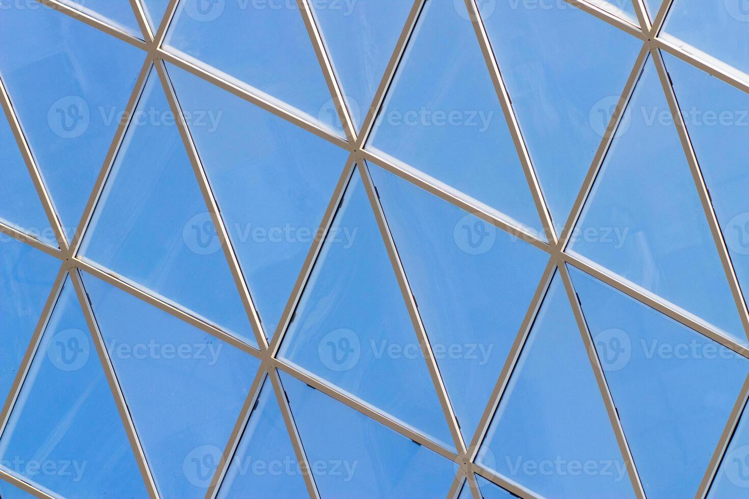 A fragment of a glass dome on the roof of the building. Geometric glass dome. Modern ceiling architecture photo