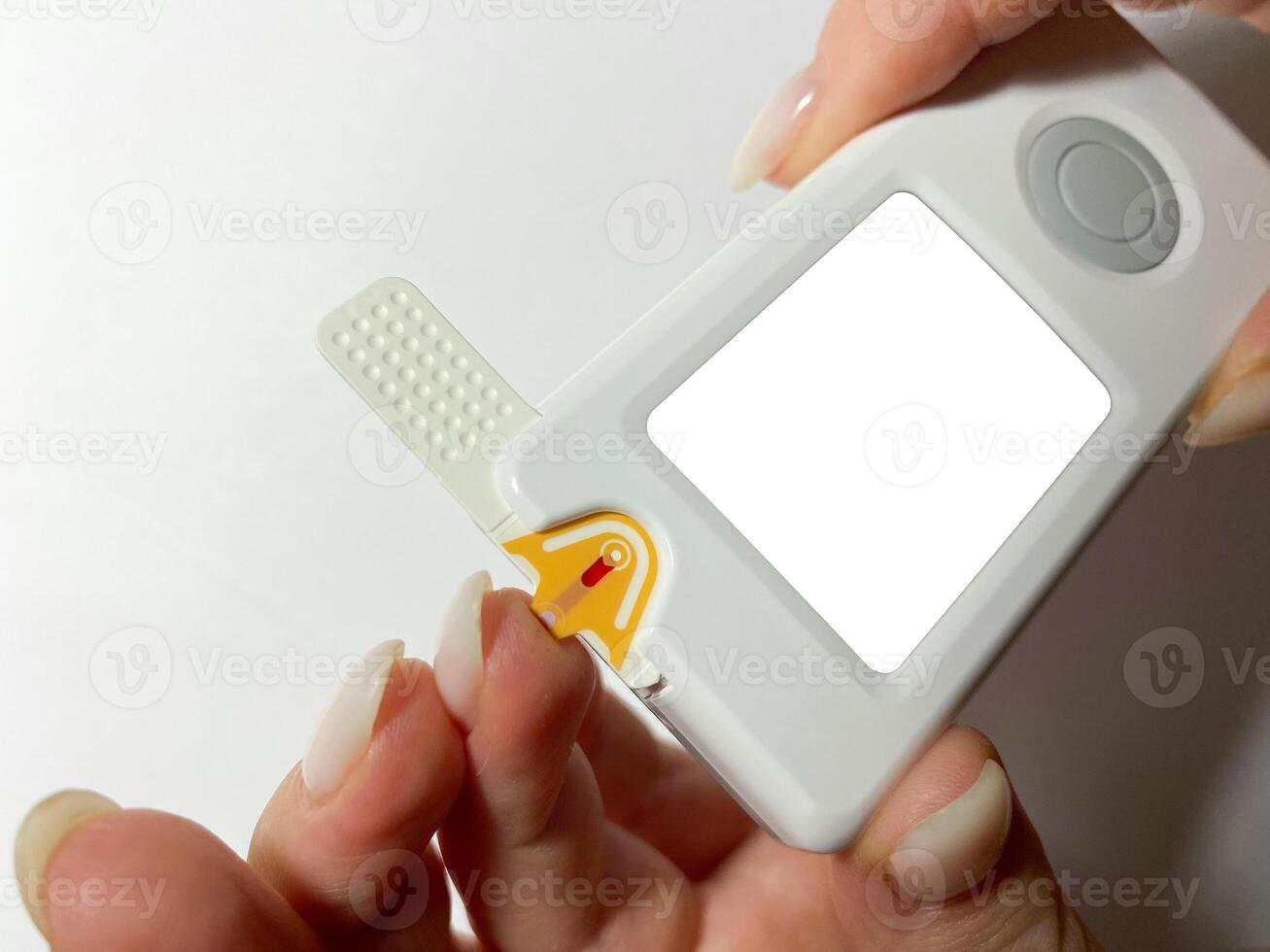 Measurement of blood sugar levels using a glucose meter with a mock-up. Piercing a finger to draw blood photo