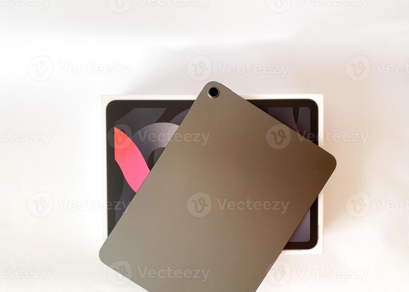 The tablet is black on a white isolated background with a mock up. Back side view of the tablet photo