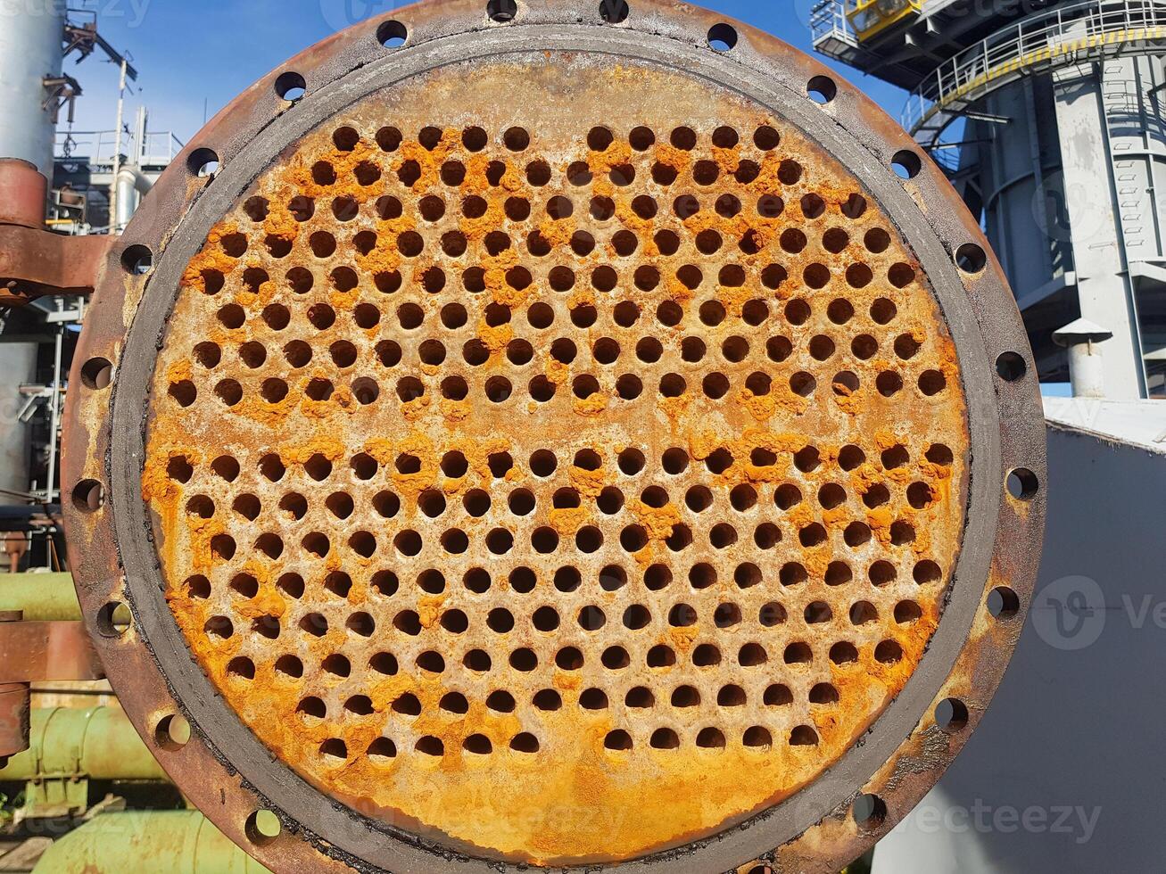 Shell-and-tube heat exchanger for heat exchange between two streams close-up. Dirty pipes in the opened heat exchanger photo
