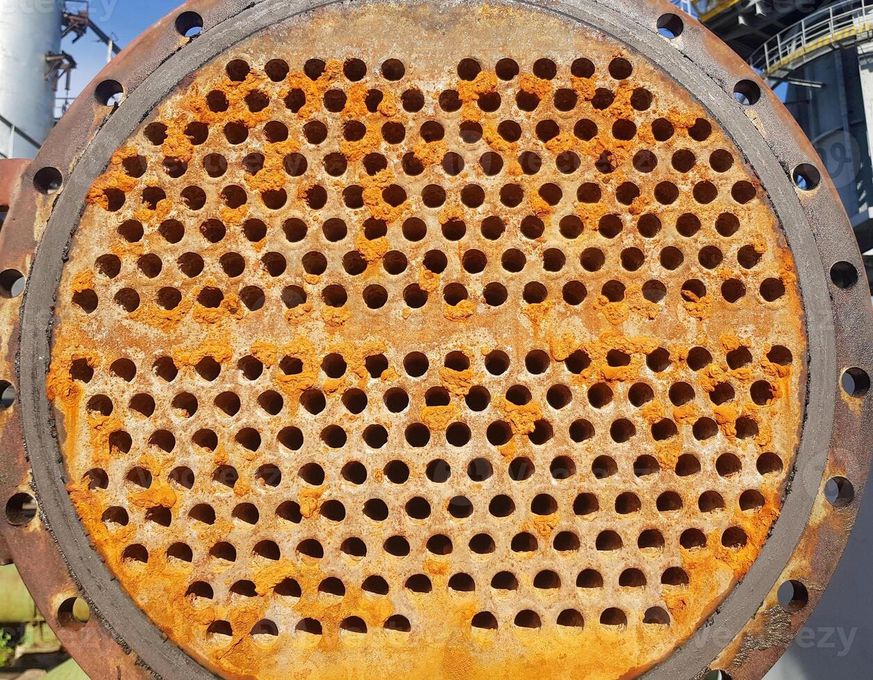 Shell-and-tube heat exchanger for heat exchange between two streams close-up. Dirty pipes in the opened heat exchanger photo