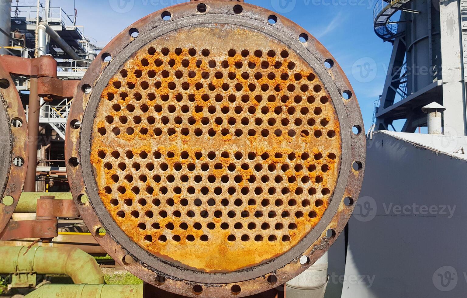 Shell-and-tube heat exchanger for heat exchange between two streams close-up. Dirty pipes in the opened heat exchanger photo