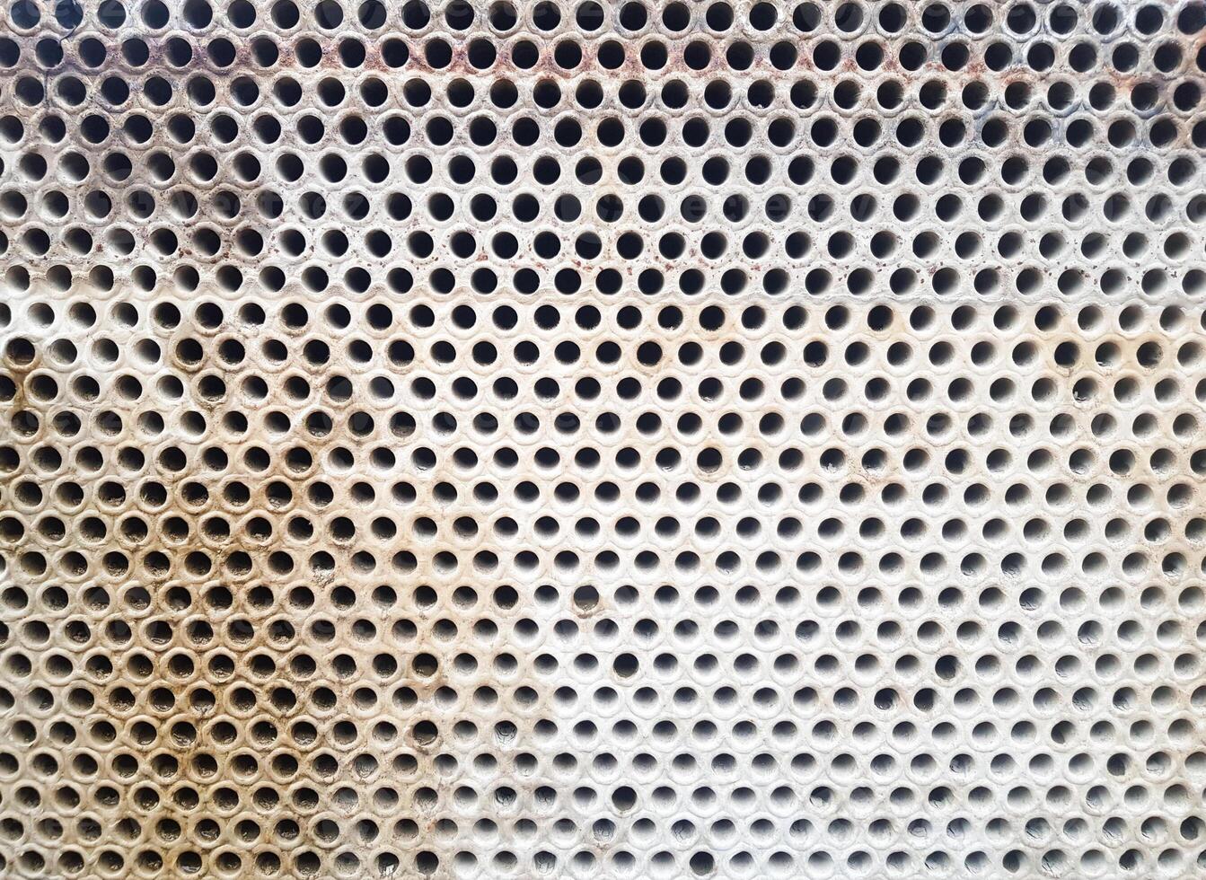 Shell-and-tube heat exchanger for heat exchange between two streams close-up. Dirty pipes in the opened heat exchanger photo