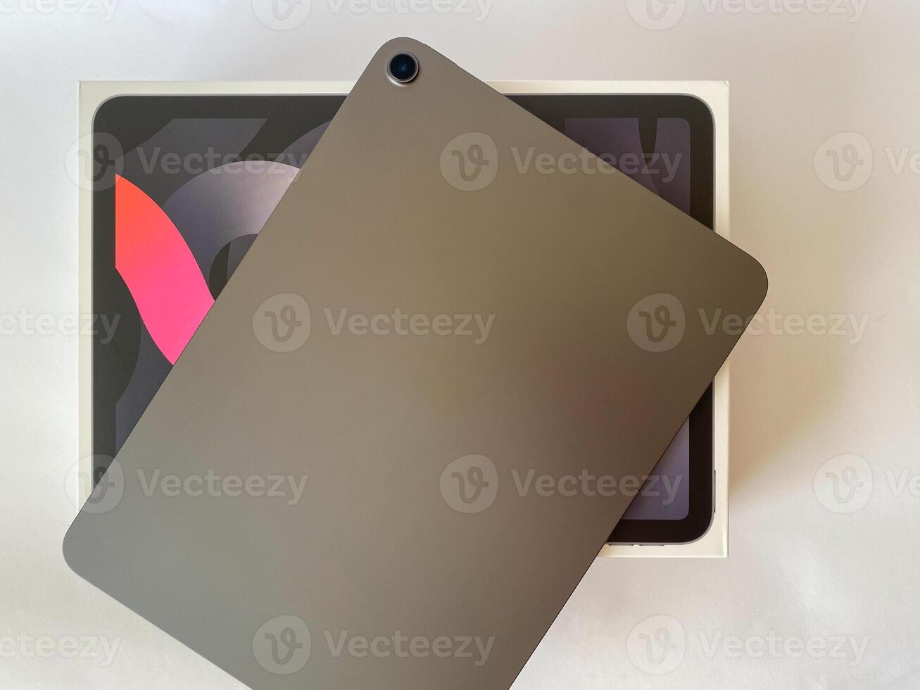 The tablet is black on a white isolated background with a mock up. Back side view of the tablet photo