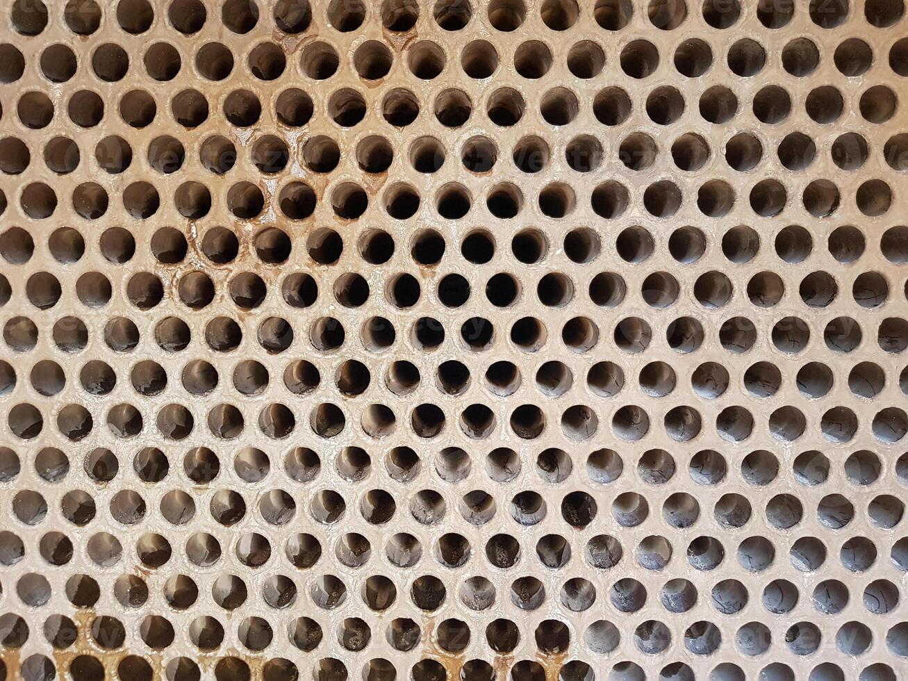 Shell-and-tube heat exchanger for heat exchange between two streams close-up. Dirty pipes in the opened heat exchanger photo
