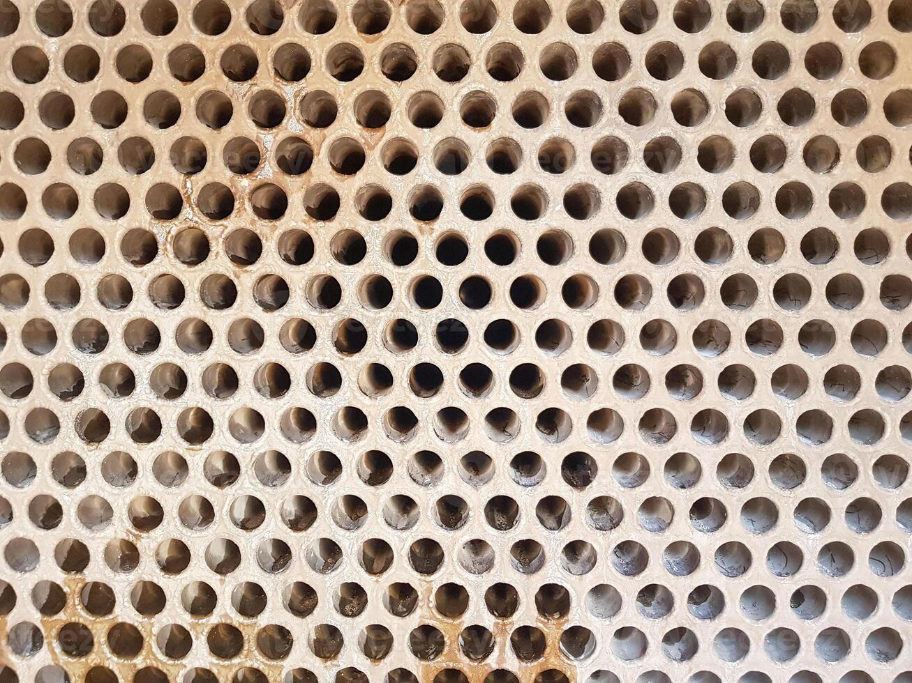 Shell-and-tube heat exchanger for heat exchange between two streams close-up. Dirty pipes in the opened heat exchanger photo