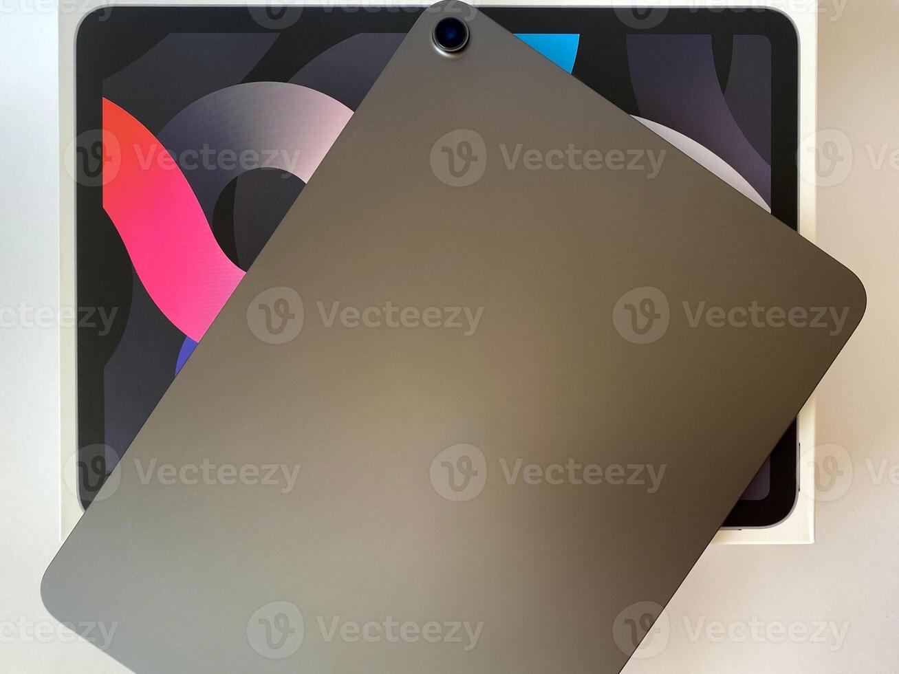 The tablet is black on a white isolated background with a mock up. Back side view of the tablet photo