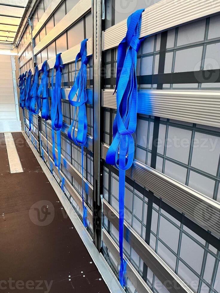 Tie-down straps for securing semi-trailer loads in close-up photo