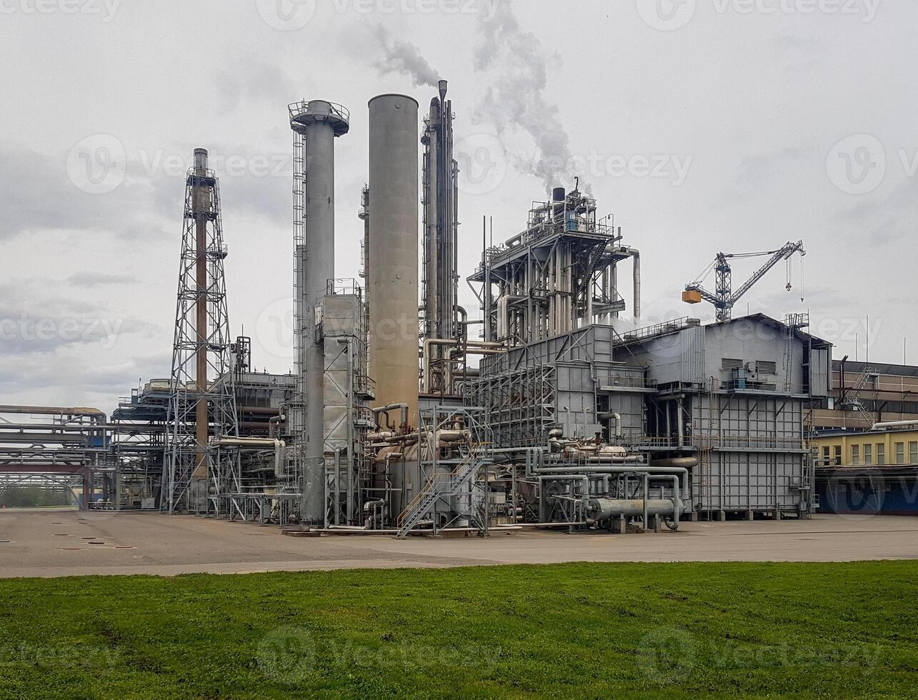 Large-capacity workshop for the production of ammonia of a petrochemical plant. The outer part of the tube furnace, shaft converter, CO2 absorber with copy space. Ammonia workshop under heavy polluted photo