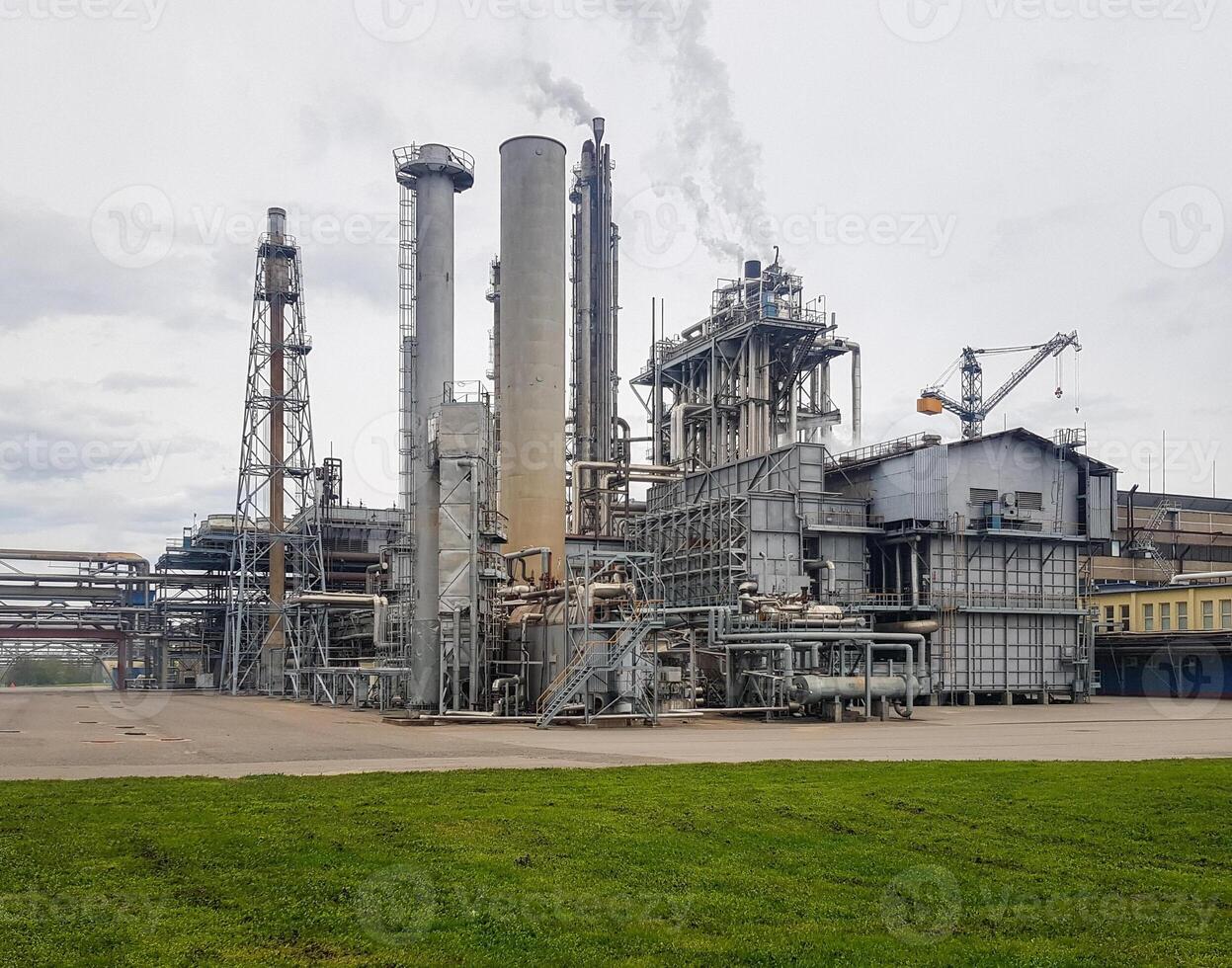 Large-capacity workshop for the production of ammonia of a petrochemical plant. The outer part of the tube furnace, shaft converter, CO2 absorber with copy space. Ammonia workshop under heavy polluted photo
