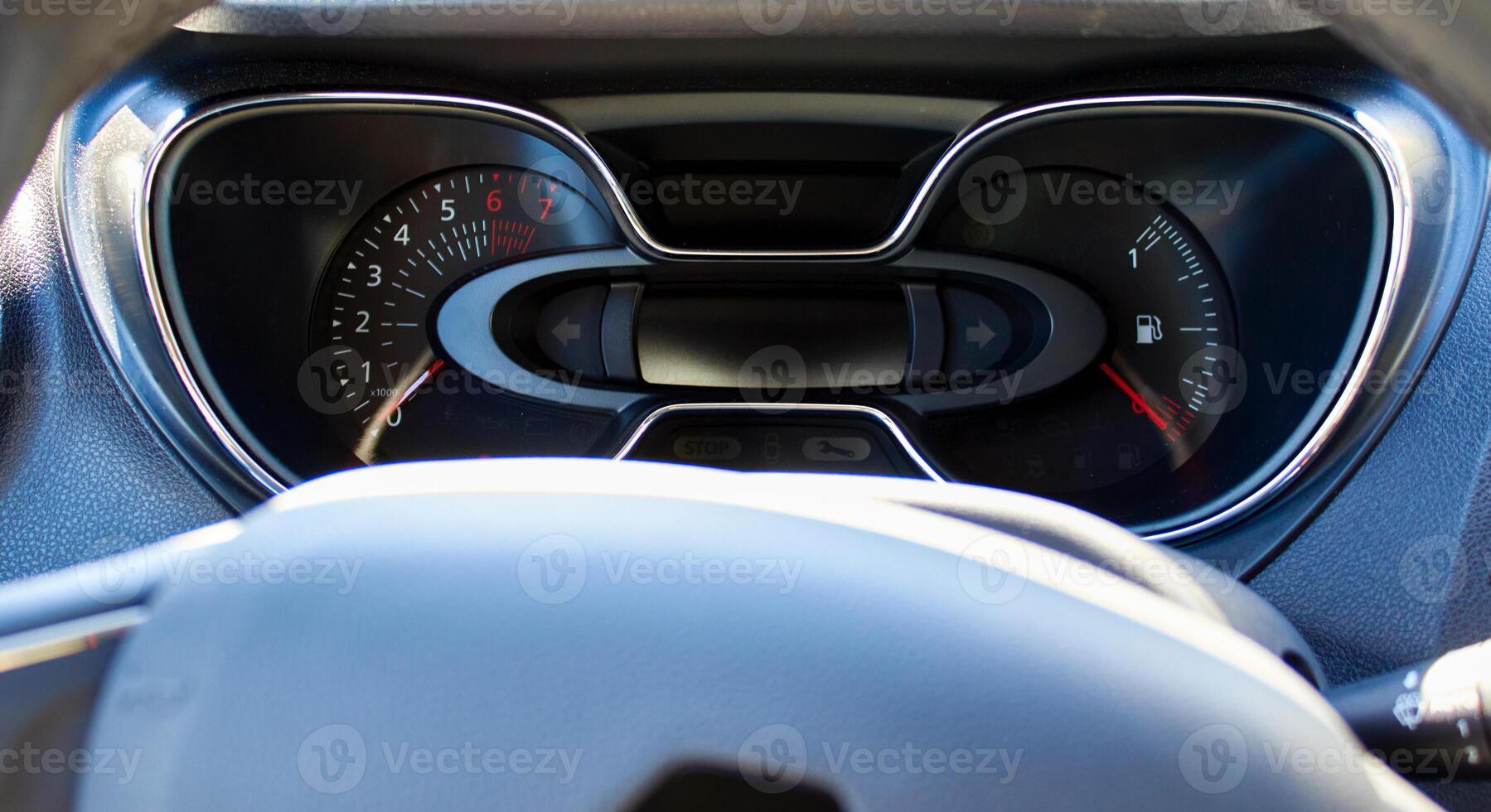 The dashboard in the car interior. The rpm and the amount of fuel in the tank photo