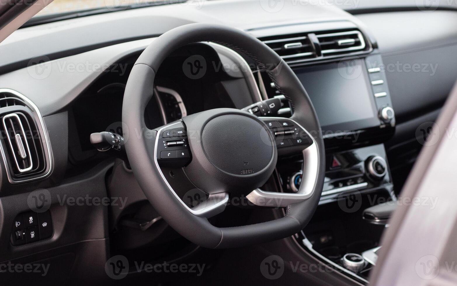 Interior of the car interior. Steering wheel, instrument panel, computer screen, automatic transmission photo