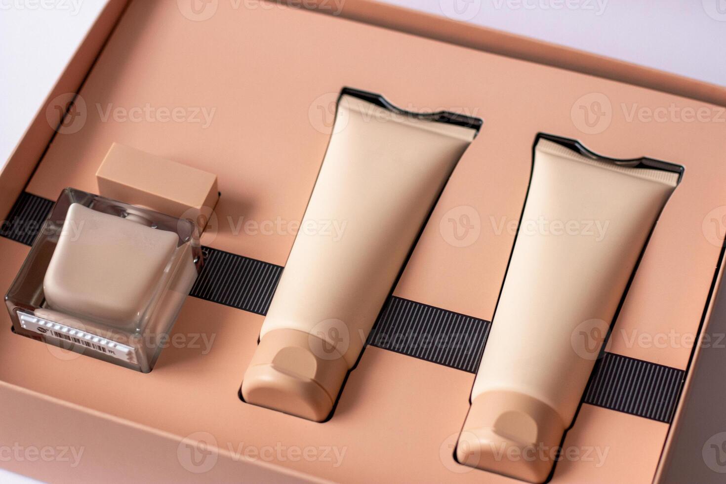 Close-up of a set of perfumed water, cream-colored shower gel in a gift box . Close-up photo on a white background