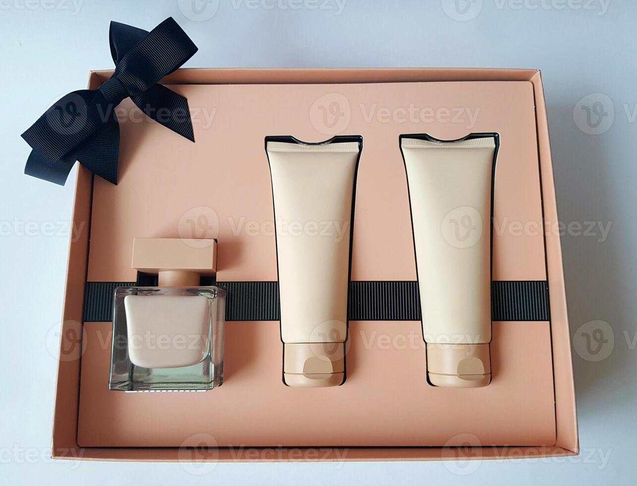 Close-up of a set of perfumed water, cream-colored shower gel in a gift box . Close-up photo on a white background