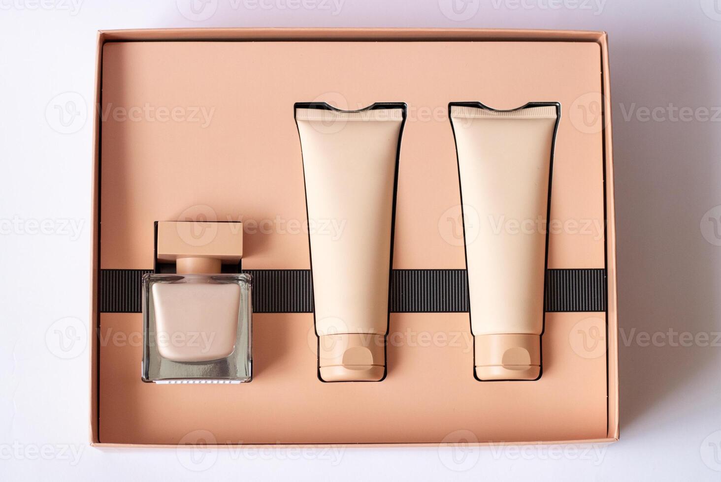 Close-up of a set of perfumed water, cream-colored shower gel in a gift box . Close-up photo on a white background