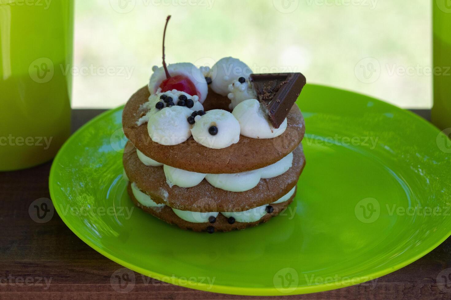 A cake or Honey cake close-up, standing on a wooden table photo