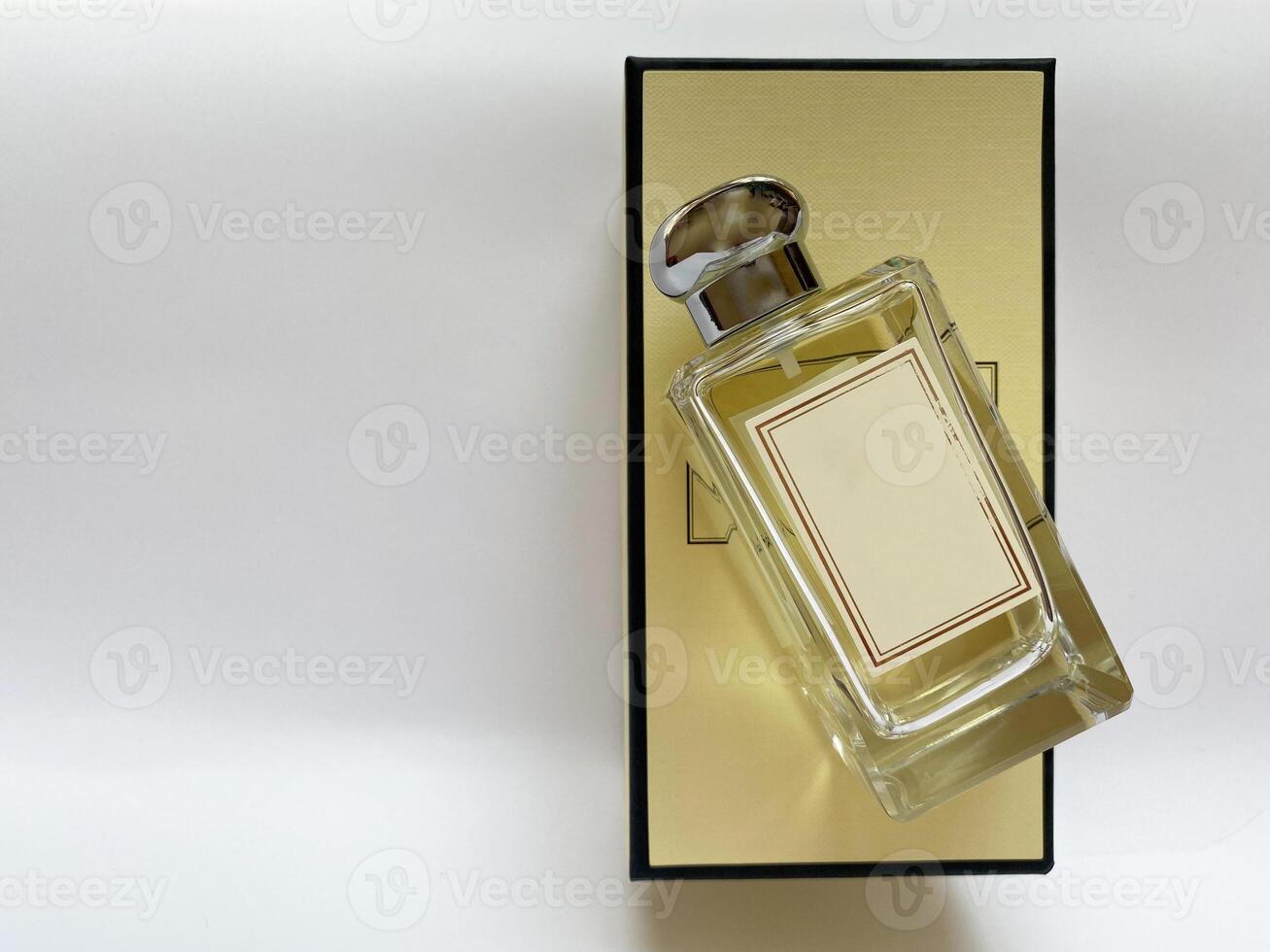 A bottle of perfume from a yellow box on a white isolated background photo